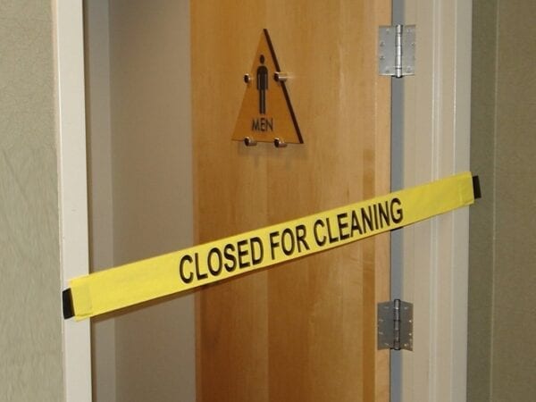 “Closed for Cleaning” Signage Placed on a Men’s Bathroom Door